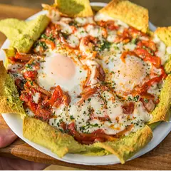 Many Ways to Enjoy Pita Bread
Pita bread is best eaten soon after baking, within 2-3 hours. You can wrap room temperature pita with plastic wrap and foil and refrigerate for a week or freeze for two months. Let frozen pita defrost slowly in a refrigerator overnight, then reheat or use for appetizers, salads, and quick meals.

1. Make a pita pizza or pie. Use pita as a crust — arrange your favorite toppings and bake in a preheated 400-450F oven.

2. Stuff and serve with yogurt sauce. Mix chopped cooked poultry or meat, grated cheese, grilled vegetables, fresh herbs, spices, and sauce to stuff pita. Eat it at room temperature, or make it hot to let the cheese melt and bind the ingredients. Reheat using a panini grill, hot skillet, or microwave.

3. Toss toasted pita pieces with greens and vegetables to make fattoush. Fattoush is a delicious Mediterranean salad, and there are many variations.

4. Bake or grill homemade pita chips. Preheat oven to 325F, cut the bread into slices, lay the chips on a sheet pan lined with a rack, and spread them evenly without overlapping. Bake for 8-12 min or until both sides are golden brown. Flip them if needed. Panini grill is faster and makes beautiful grill marks. Besides various vegetable dips and spreads, my favorite way of serving pita chips is with pesto, fresh tomatoes, and a slice of burrata.

5. Stuff pita with your favorite burger and grill. A thin layer of ground beef or lamb will cook inside the pita, letting the bread absorb the fat and meat juices.

6. Use pita as a base for oven-baked shakshouka. It’s a dish of eggs poached in a sauce of tomatoes, chili peppers, and onions, spiced with harissa. Replace tortilla with pita bread for the Mexican version of this dish — huevos ahogados or “drowned eggs” — eggs poached with salsa.

7. Grill until warm. Brush pita bread with olive oil and grill until it gets toasted and crispy around the edges. Serve with BBQ meat and poultry.