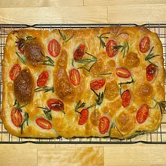 This turned out deliciously! However, mine didn't rise as much as I would like, and was not as fluffy as I would like. Any tips for improving that next time? 

Info that may help: I followed all instructions closely, used a digital scale to measure, instant yeast, and Bob's Red Mill Artisan Bread Flour. During the stretch and fold part of the process, my dough stayed quite wet and gloopy, and never quite became anything I would describe as a "ball" that could be folded. It took me about 32 mins to bake it as pictured, though that could just be my oven. I would really appreciate any suggestions you may have!

All in all, I'm very pleased with how it came out considering it's my first time EVER making bread! I already went back for seconds :)) Would definitely recommend this recipe to others. Here's hoping my next batch will be even better!