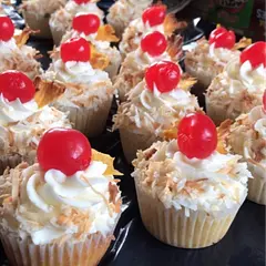 I love this recipe! However, I did make some adjustments to the garnishes. I toasted the coconut shavings, let them cool and then I put them on the sides of the cupcake. For the pineapple wedges, I dehydrated pineapple slices and used that instead. I also took the stems off of the cherries and put the side that had the stem facing down into the icing.