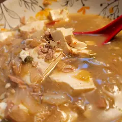 I have made this recipe many times. You can make it very spicy to mild, depending on the kimchi you use and the amount of gochugaru. If you don't like spicy food, use white kimchi and as little as 1 teaspoon of gochugaru. I personally prefer it made with mild kimchi and 2 tablespoons of gochugaru. I make it with tuna. It is worth it to use a better quality tuna. My favorite is Tonnino's Yellowfin Tuna packed in water. 