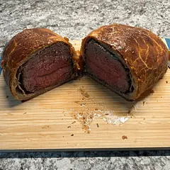 Used a New York Strip Roast since a beef tenderloin was unattainable. For my first attempt at this cooking method was pleasantly surprised how well it turned out. Credit goes to the detailed instructions and great video. Thank you Tyler!

Freezing Cooked Beef Wellington
1. Cool Completely: Allow the cooked Beef Wellington to cool down to room temperature.
2. Wrap Properly: Wrap it tightly in storage wrap to prevent freezer burn.
3. Add Foil: After wrapping, cover it with a layer of aluminum foil for extra protection.
4. Use a Freezer Bag: Place the wrapped Wellington in a freezer-safe bag to keep it secure.

Storage Duration
Cooked Beef Wellington can be frozen for up to three months. 

Reheating Instructions
When ready to serve, thaw the Beef Wellington in the refrigerator overnight.
Preheat your oven to 350°F (175°C) and warm the Wellington for 15 to 20 minutes, or until heated through.