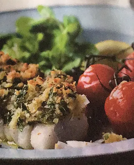 Crushed cod with grilled tomatoes