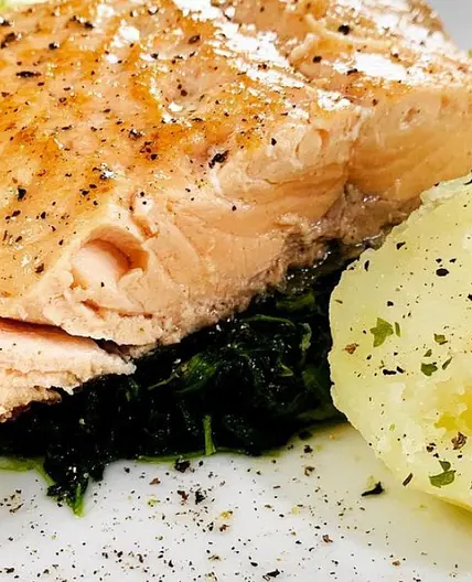Salmon fillet on parsley potatoes and spinach
