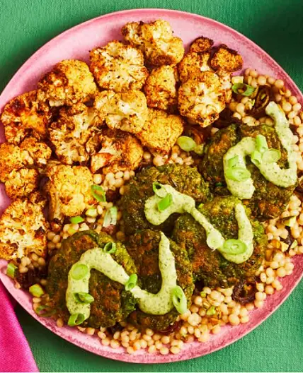 MOROCCAN-STYLE GREEN PEA FRITTERS pistachio date couscous, roasted cauliflower, green goddess dressing