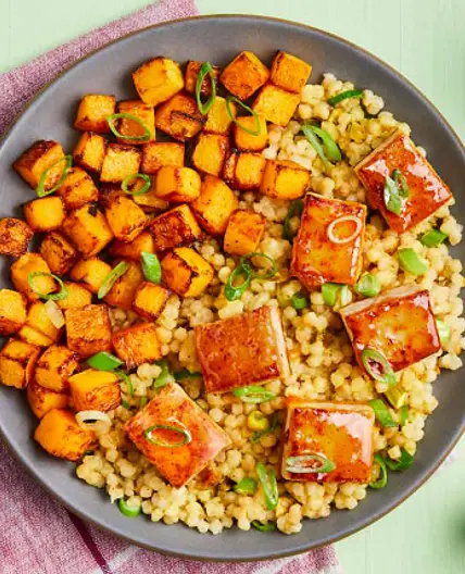 APRICOT-GLAZED TOFU butternut squash, pearl couscous with pistachios & tahini sauce