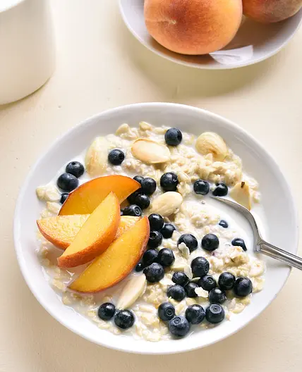 Oat Cinnamon Porridge with Fresh Fruits & Omega Seeds Mix.