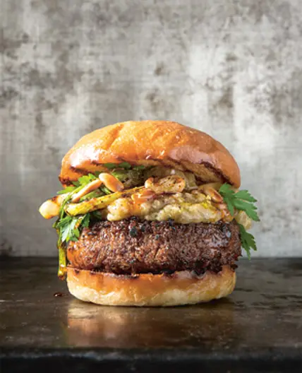 BLACK BEAN BURGER WITH BABA GHANOUSH, GRILLED SPRING ONIONS AND ROASTED PINE NUTS