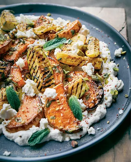 Roasted squash and zucchini with whipped feta and
pistachios
