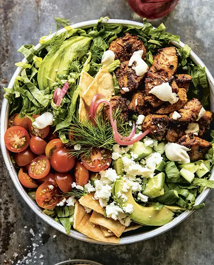 spiced chopped chicken salad with pita crisps and tahini vinaigrette