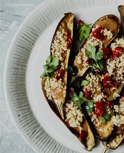 Soft Baked Eggplant with Crispy Millet, Calabrese Peppers & Honey-Almond Drizzle