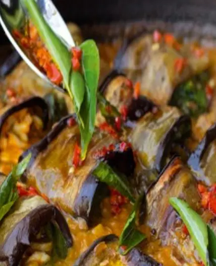Stuffed aubergine in curry and coconut dal