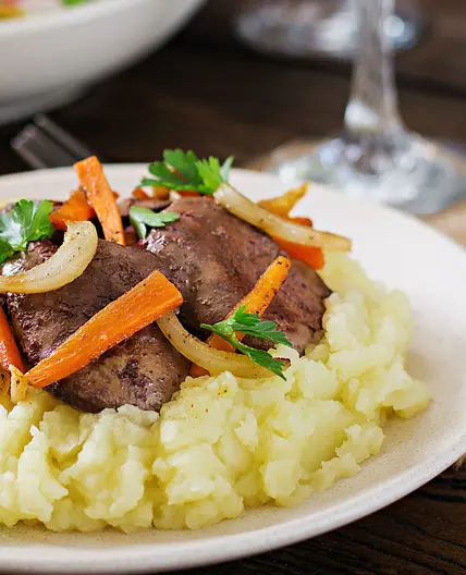 Chicken liver with caramelized onions over mashed potatoes