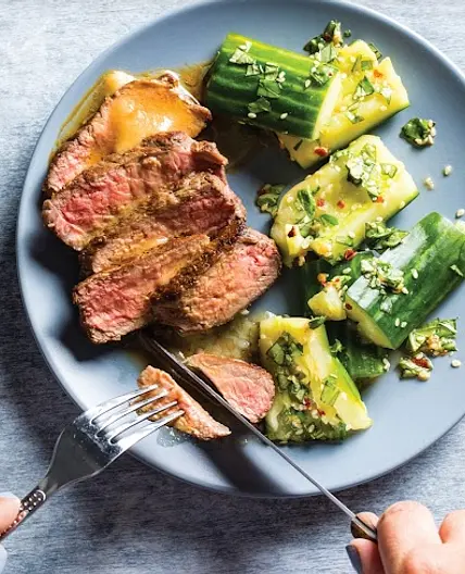 Pan-seared strip steak with smashed cucumber salad