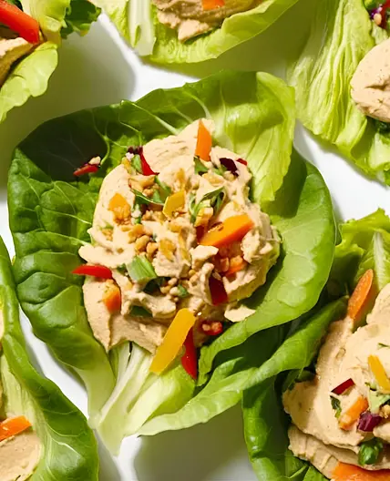Ensaladas de hojas de lechuga rellenas de hummus y verduras crujientes