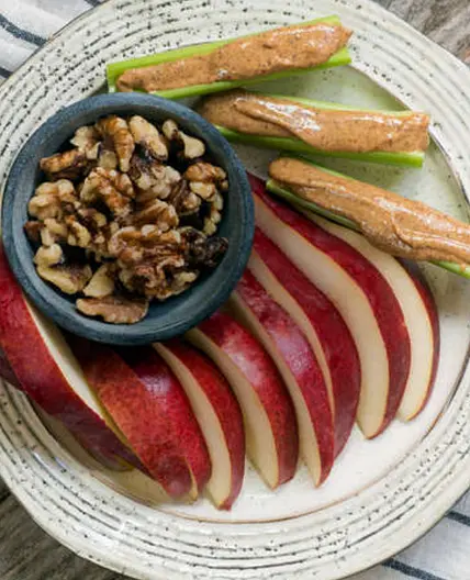 Bento with almond butter, celery, pear slices & walnuts