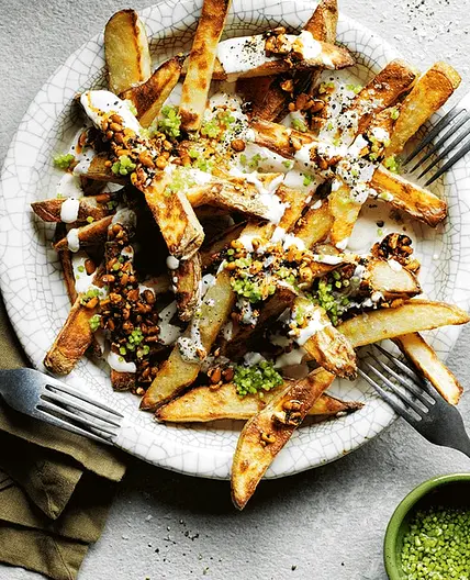 Yotam Ottolenghi's loaded fries with tahini yoghurt and smokey-sweet nuts