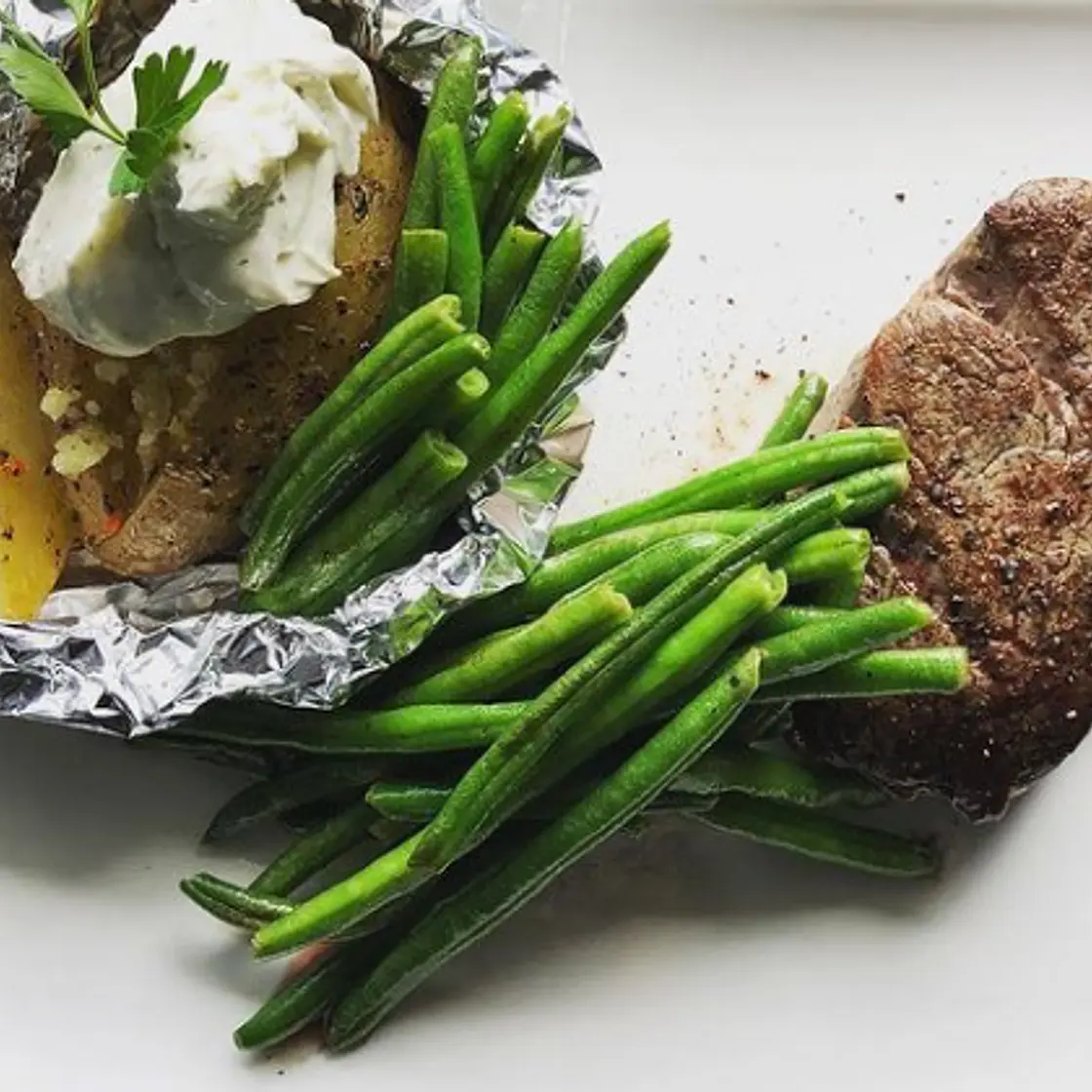 Fillet steak, baked potato and beans
