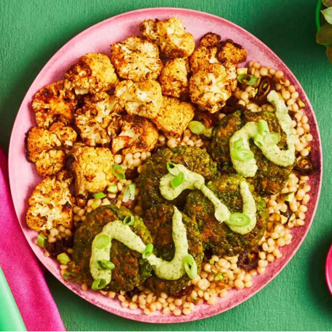 MOROCCAN-STYLE GREEN PEA FRITTERS pistachio date couscous, roasted cauliflower, green goddess dressing