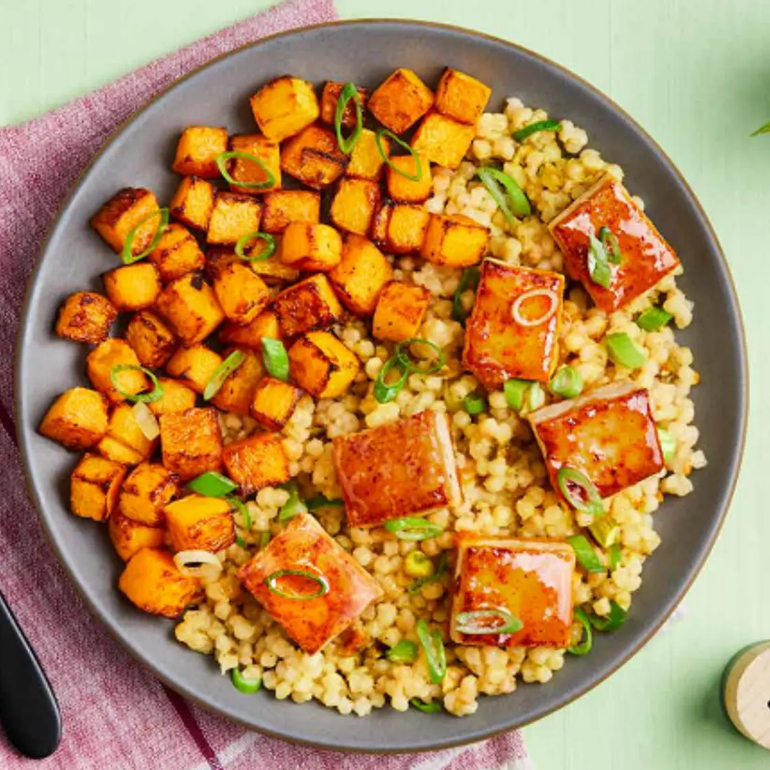 APRICOT-GLAZED TOFU butternut squash, pearl couscous with pistachios & tahini sauce