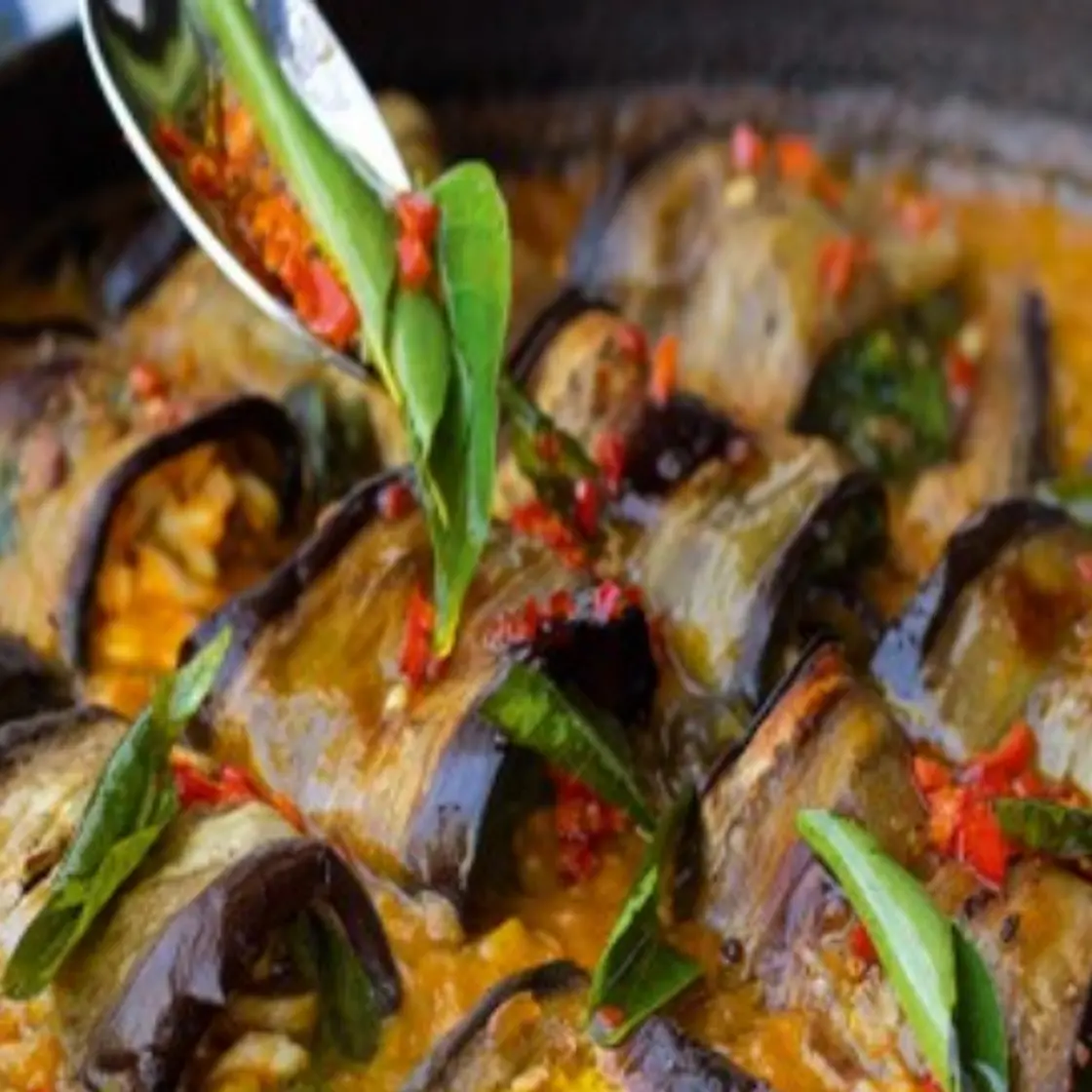 Stuffed aubergine in curry and coconut dal