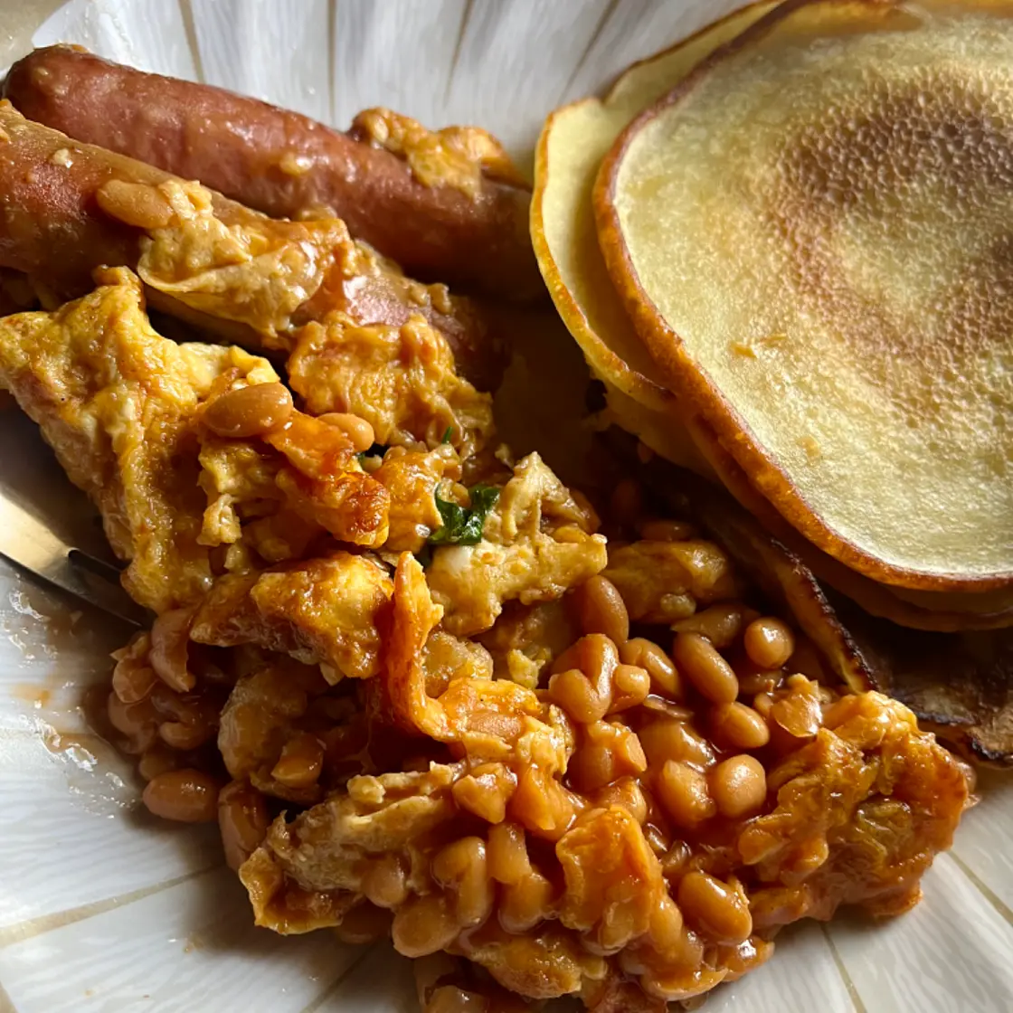 Pancakes and shrimp fried eggs with chicken sausage.