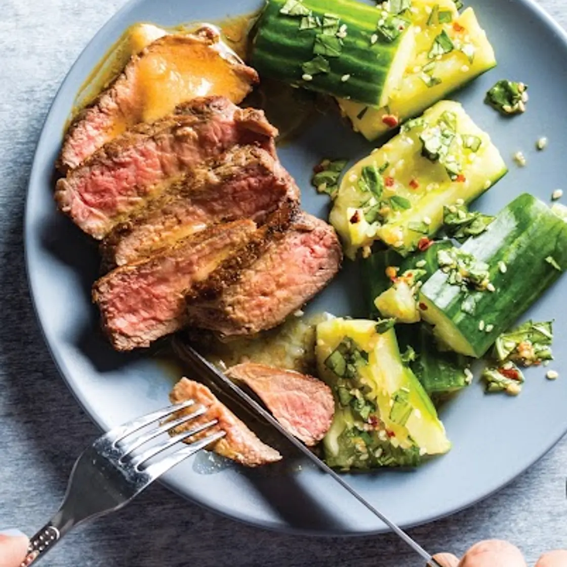 Pan-seared strip steak with smashed cucumber salad