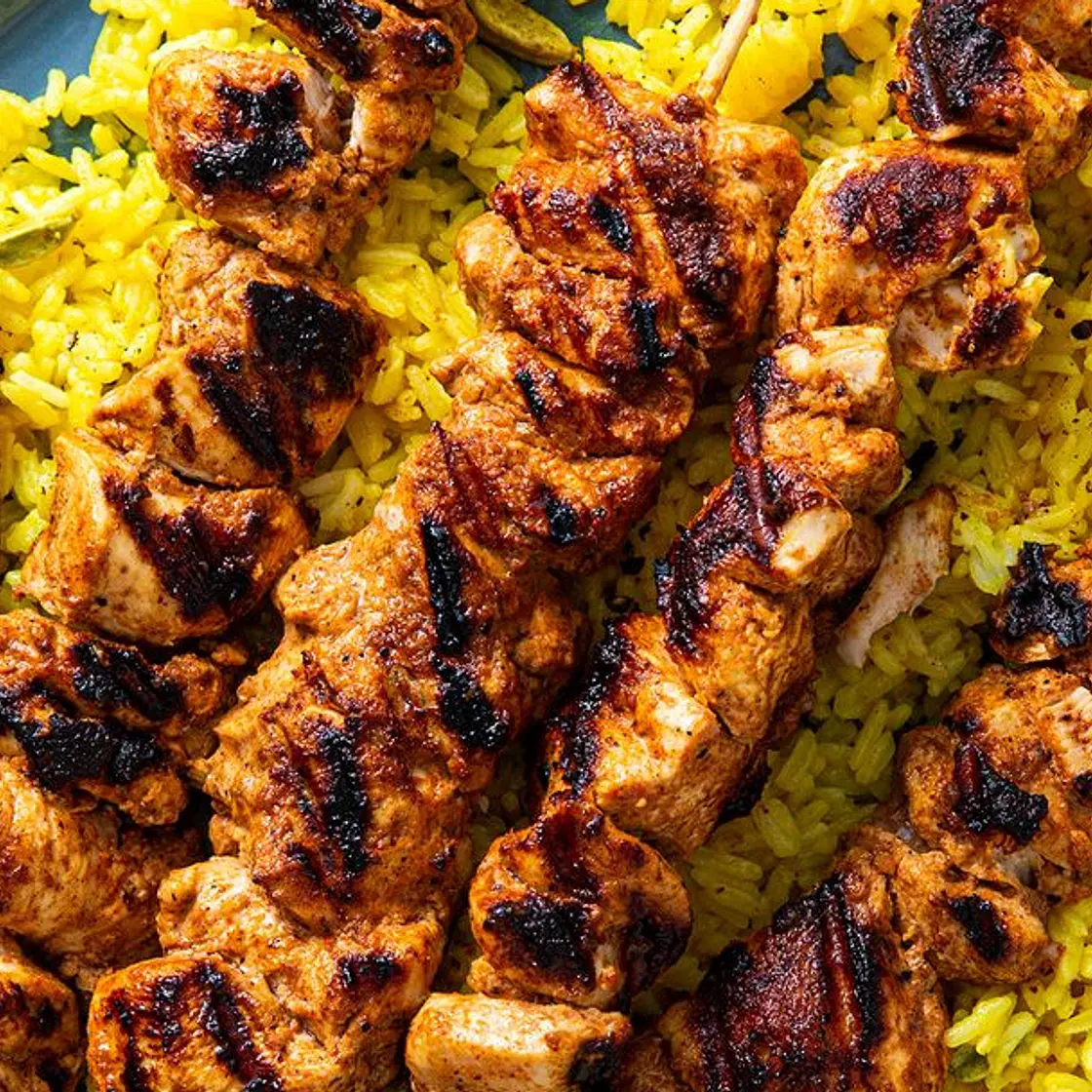 Chicken tikka skewers with rice