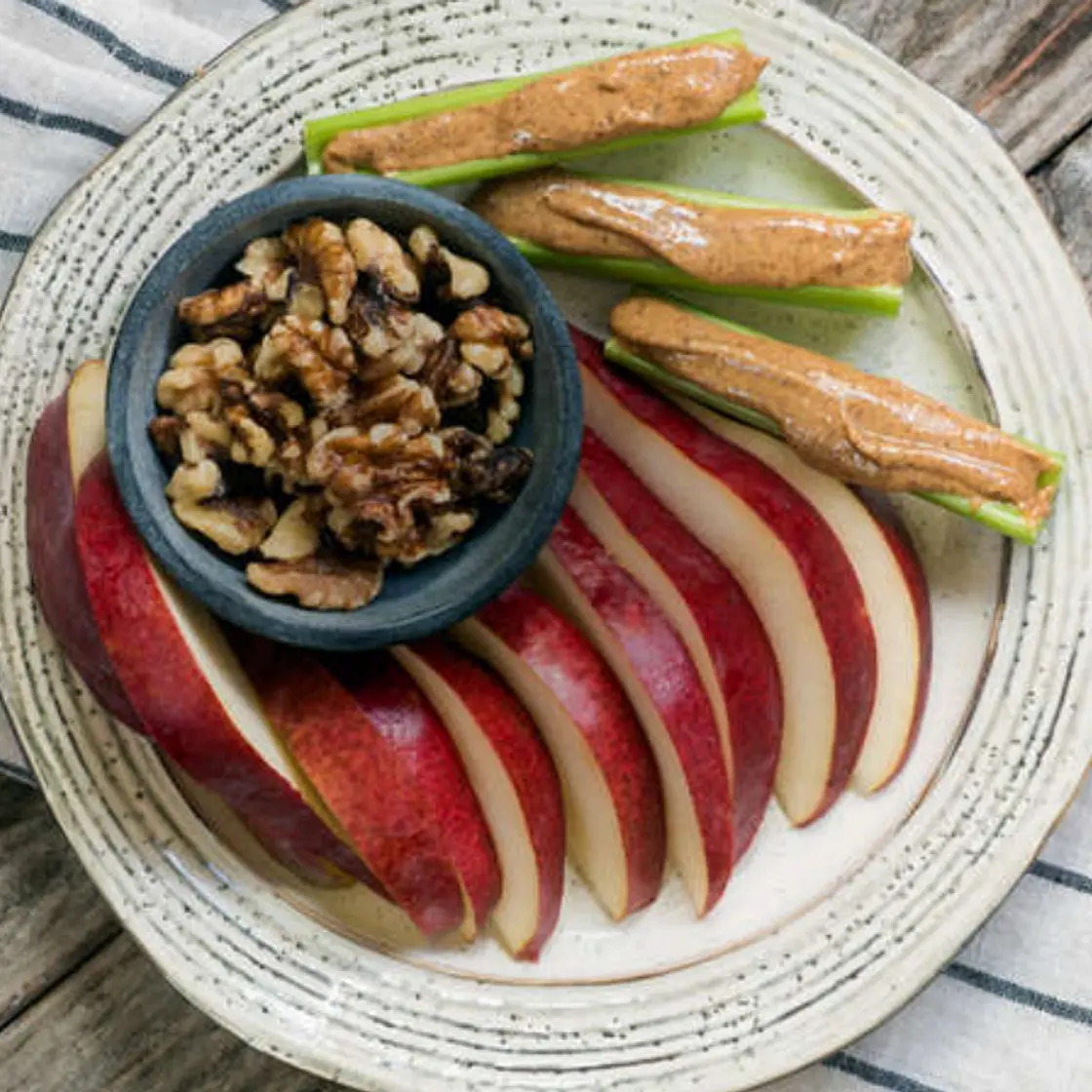 Bento with almond butter, celery, pear slices & walnuts