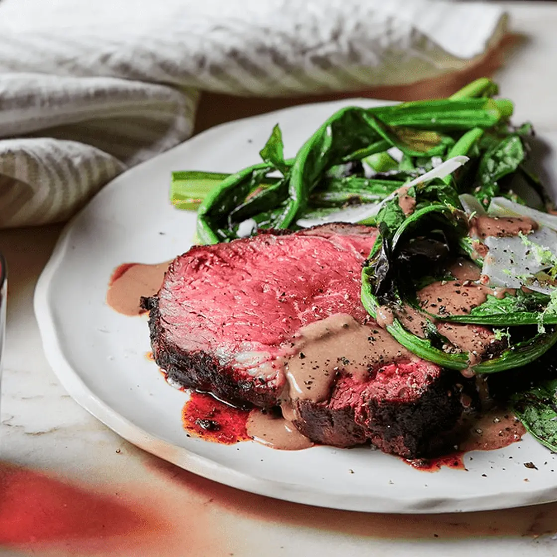 Charred porcini scotch fillet with bitter greens and black garlic bagna cauda sauce
