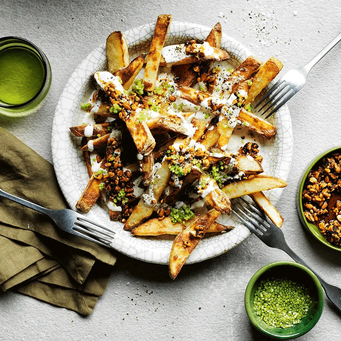 Yotam Ottolenghi's loaded fries with tahini yoghurt and smokey-sweet nuts