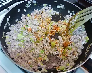 When the pork is cooked through, stir in the doubanjiang.