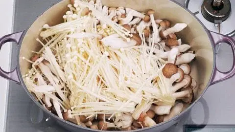 Heat a large heavy-bottomed pot over medium-low heat and add the butter for the mushrooms, along with the crimini, shimeji, and enoki mushrooms and then sprinkle on the salt. Cover the pot with a lid and let the mushrooms steam for 10 minutes.