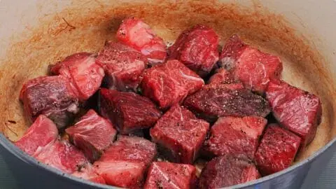 Add the olive oil for the beef, and then spread the cubes of meat in a single layer around the pot. Be sure to leave a gap between each piece of meat, so it browns evenly, and let the beef brown undisturbed (this will take about 3 minutes).