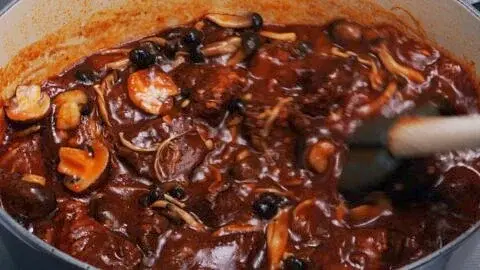 When the beef is tender, return the sauteed mushrooms to the pot.