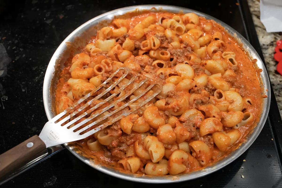Add the noodles to the sauce, and gently stir the noodles in.