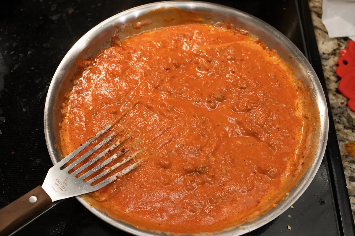 Add the heavy cream to the sauce, stirring until it is fully incorporated.