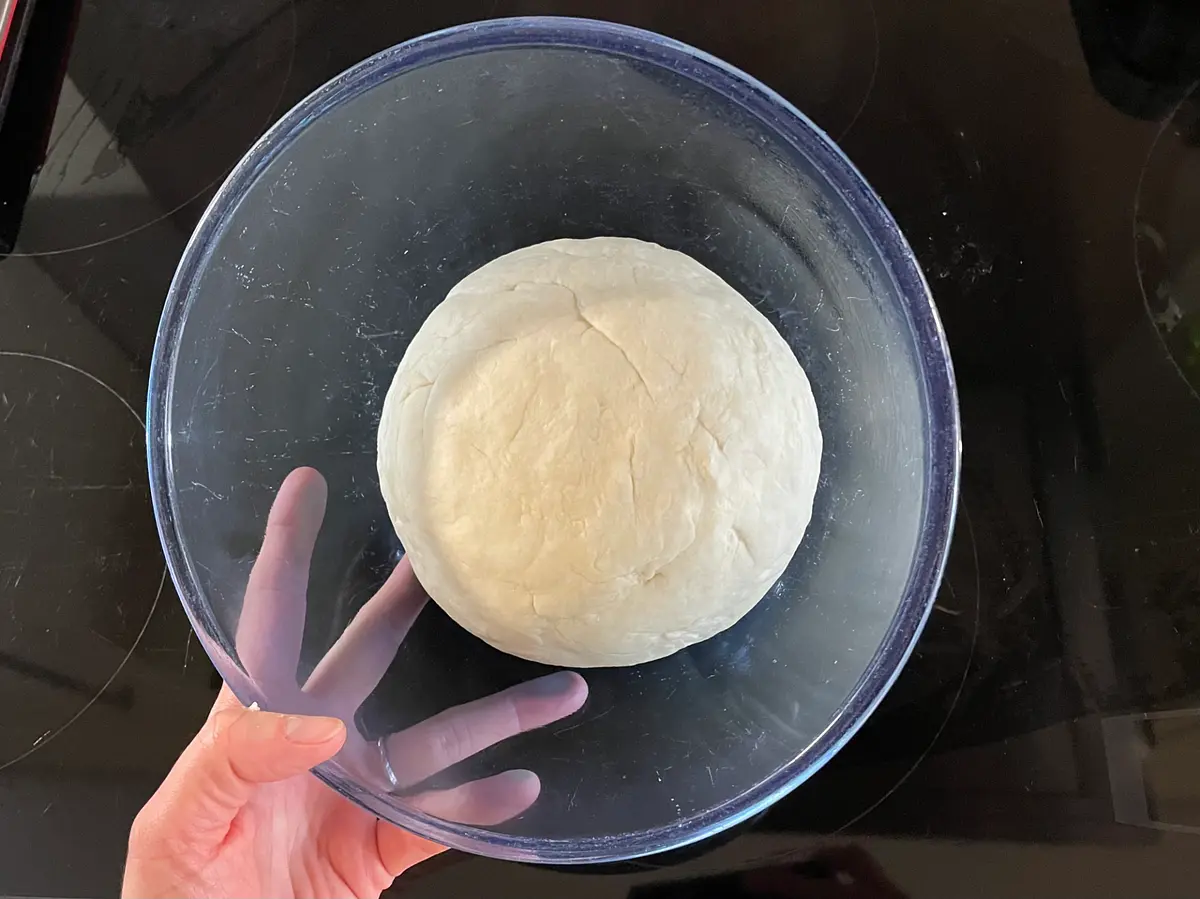Wipe a medium sized bowl with some oil, then put your ball of dough into the bowl. Cover it with a damp tea towel, and put it somewhere dark (and warm-ish, if you can) – a cupboard is fine. Leave your lovely dough to prove until it’s doubled in size. This will probably take about two hours, but working it 15-30 mins or so either side won’t be a disaster.