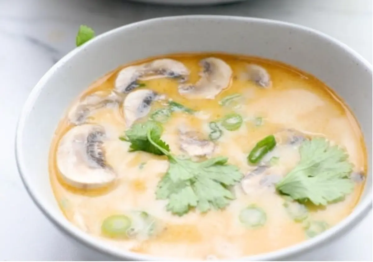 Add fish sauce, coconut aminos (or coconut sugar), makrut lime leaves, culantro, and lime juice, plus more of each to taste. Cook on medium for 2 minutes, bring to a boil for 30 seconds, remove from heat. Ladle into serving bowls and top with sliced green onions and garnish with culantro if desired.