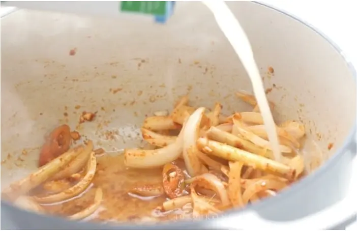 In a medium pot, heat the coconut oil over medium heat. Add the shallot, garlic, chile, galangal or ginger, lemongrass, salt, and red curry paste and cook, stirring frequently, for 5 minutes, or until shallots are softened. Add chicken broth and bring to a boil. Reduce heat and simmer uncovered for 30 minutes.