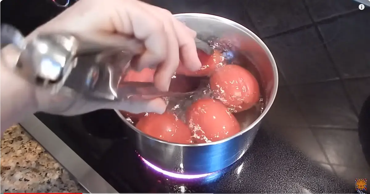 Put the tomatoes in a pot with boiling water. Remove the stem before.
When tomatoes start to pop remove them to cool down