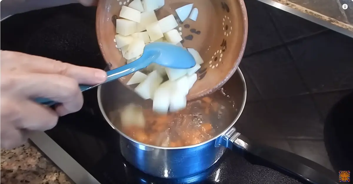 Put the carrot first in a pot with boiling water.
After two or three minutes add the potato.
Five minutes later after both carrot and potato are semi-coocked, turn it off and set it aside