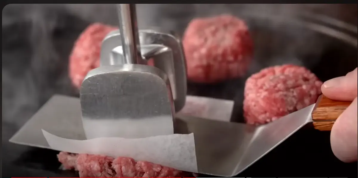 Start frying patties and swash them with baking paper until they're flat