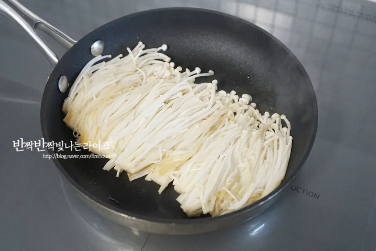 달군 팬에 식용유 1 큰 술을 두르고 버섯을 넓게 펼쳐 올려줍니다.