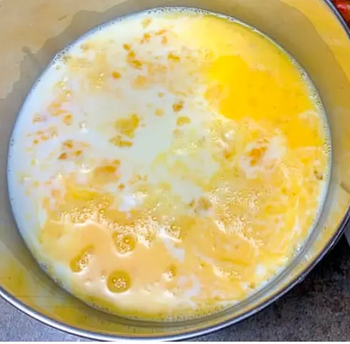 Add milk, mozzarella, and ground mustard to eggs.