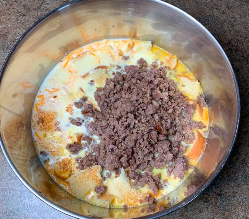 Add cooked ground sausage to egg mix. Me x until well combined.