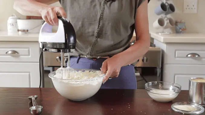 While the cakes are cooling, you can make the chocolate mousse. Place the cream and sugar in a mixing bowl and beat until stiff. Then set aside.