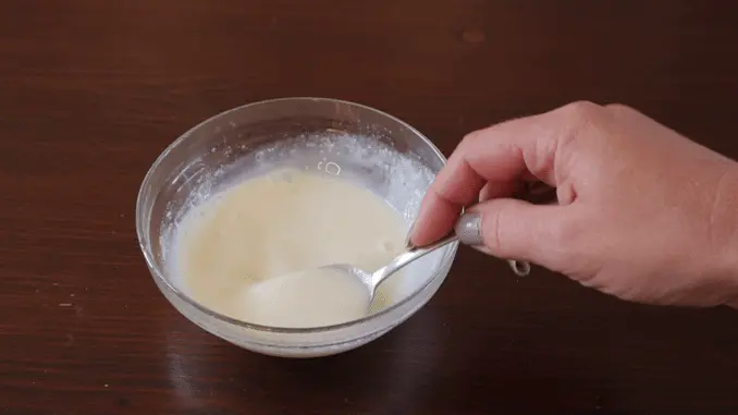 In a separate bowl, heat the milk in the microwave for 45 seconds and then add the gelatin powder to it. Stir it for a minute or two, until all the gelatin has melted and it's lump free. If there are any lumps, you can heat it for a couple more seconds in the microwave, and continue stirring until it's smooth.