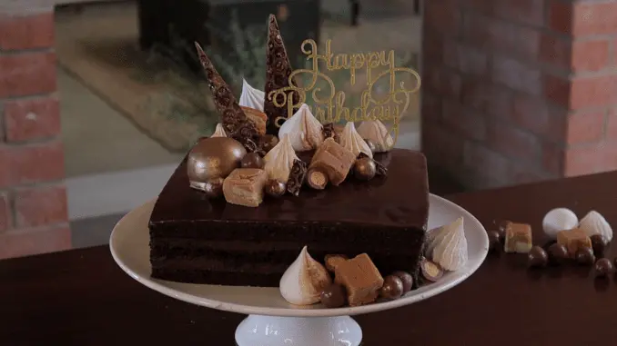 Decorate the cake with anything you like. I've used a combination of meringues, fudge, chocolate and Whispers, and rolled them in gold dust to give a beautiful shine. Enjoy!