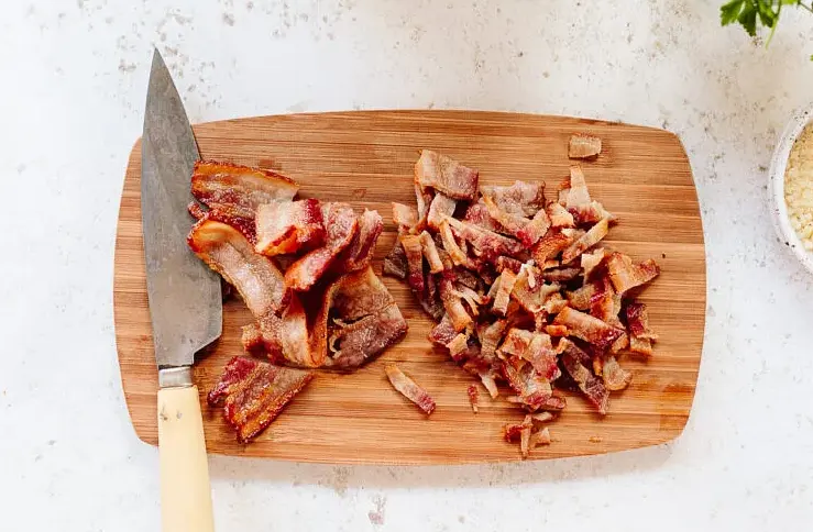 Bake the 1 lb. bacon at 400 degrees until crisp (15-20 minutes), flipping halfway through. Like skinning a cat, which is not called for in this recipe, there many ways to cook bacon. Do as you please when makin' bacon. If done correctly, you will cooking MS's like a pound of bacon. Drain on paper towels to cool. Note: You can also arrange the bacon on a rack in the sheet pan. Chop the bacon into chunky pieces.