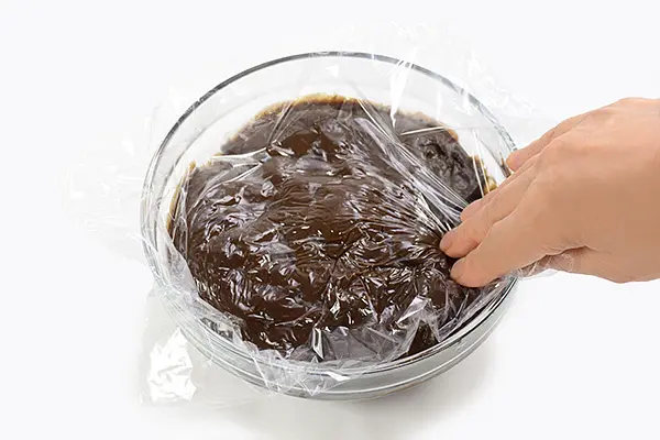 Stir and cook mixture over medium heat. Just before the mixture boils, remove from heat, stir in butter, chocolate chips, vanilla extract and mix until dissolved. Transfer filling into a flat container, place plastic wrap directly on surface of the filling to prevent any skin from forming. Refrigerate for at least 1 hour to chill.